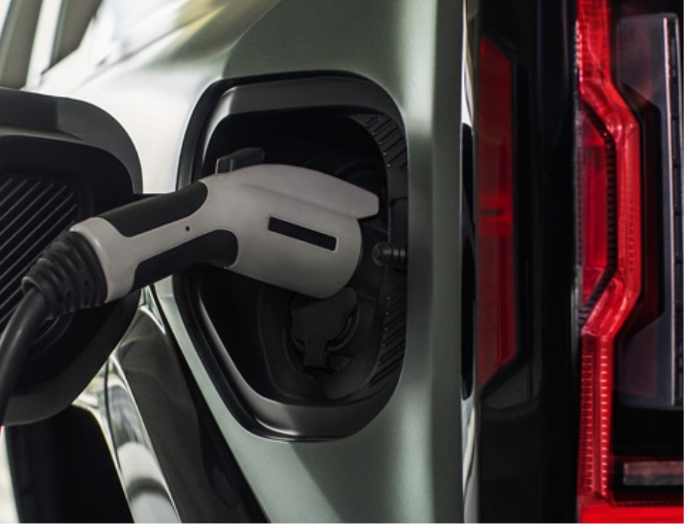 Close up of charging port with charger plugged in on a GMC Hummer EV SUV - Ray Miller GMC in FLORENCE AL